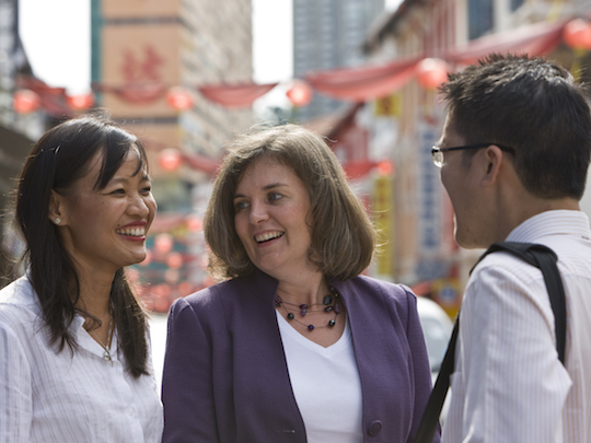 A photo of three Team Members from the Trade Profession in Southside Singapore, it is a sunny day and they are outside chatting together