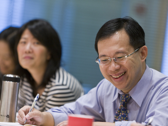 A photo of Trade Profession Team Members, in Taiwan. A man and a woman are sitting at a desk.