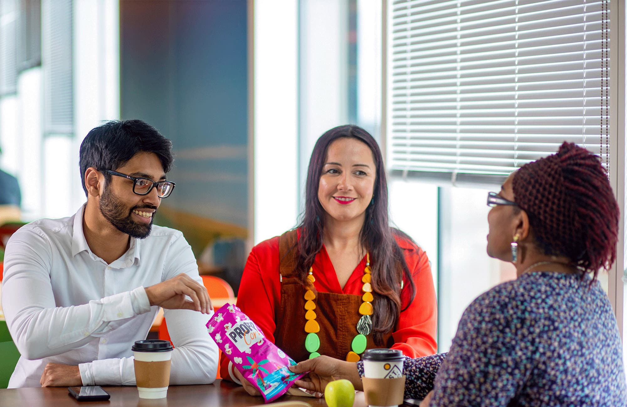 Image of 3 colleagues chatting and smiling