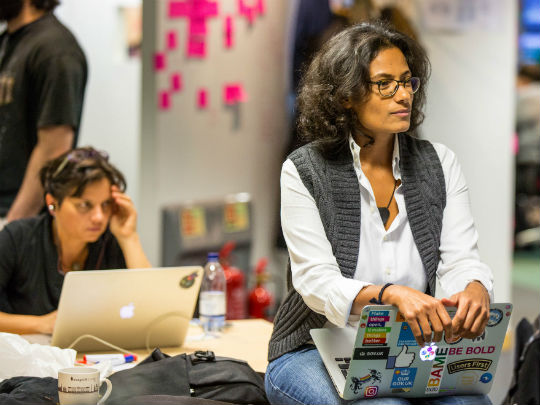 Woman With Glasses Sat Down With Laptop
