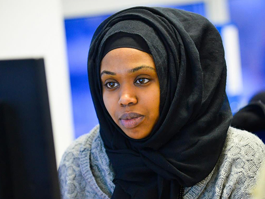 A Woman Working intently At Computer