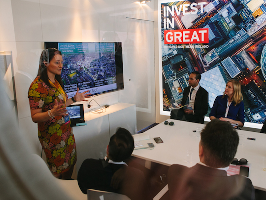 A woman giving a presentation at the Department for International Trade, to some colleagues